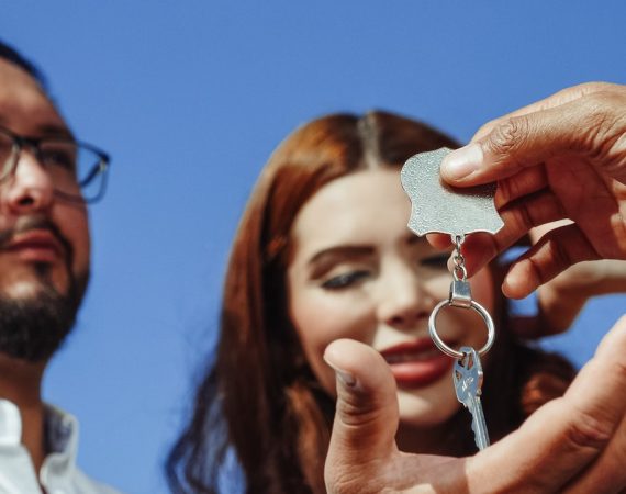 Couple being handed keys to new house